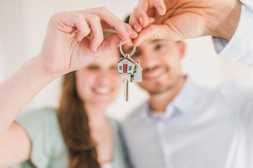 a couple holding the key to their long-term investment